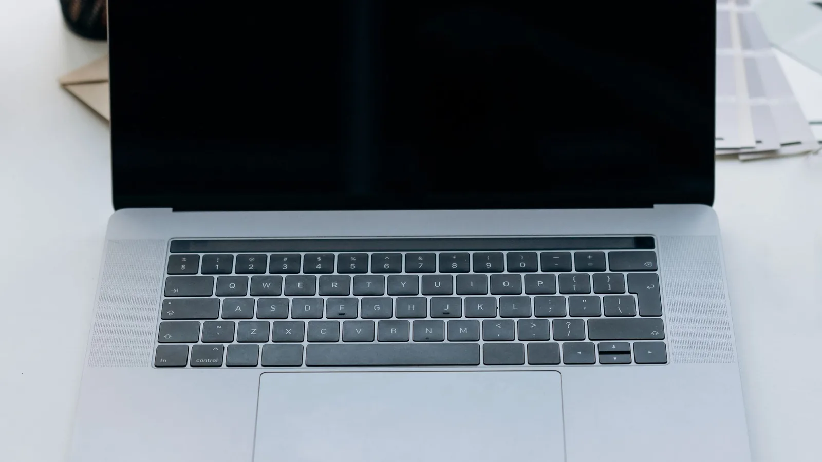 Open laptop with a blank screen on a white desk